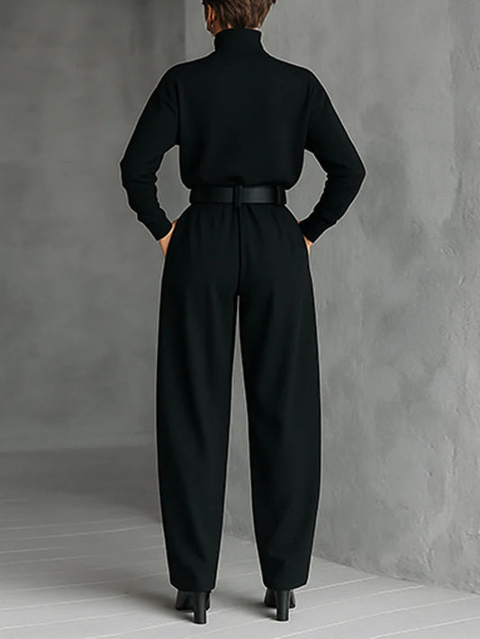 Black turtleneck top and straight-leg trousers with matching belt