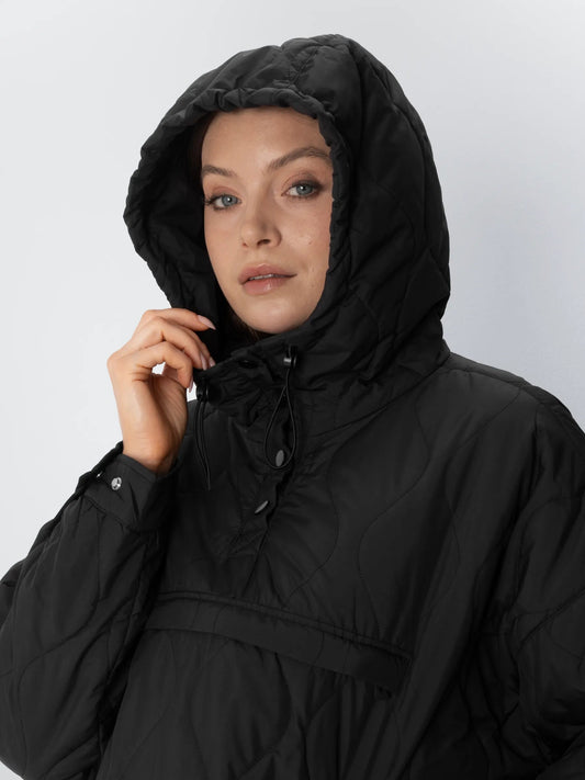 Black unisex quilted puffer hoodie shown in a relaxed fit