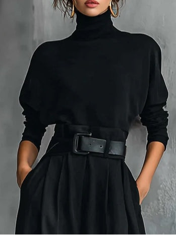 Black two-piece trouser set styled with matching waist belt