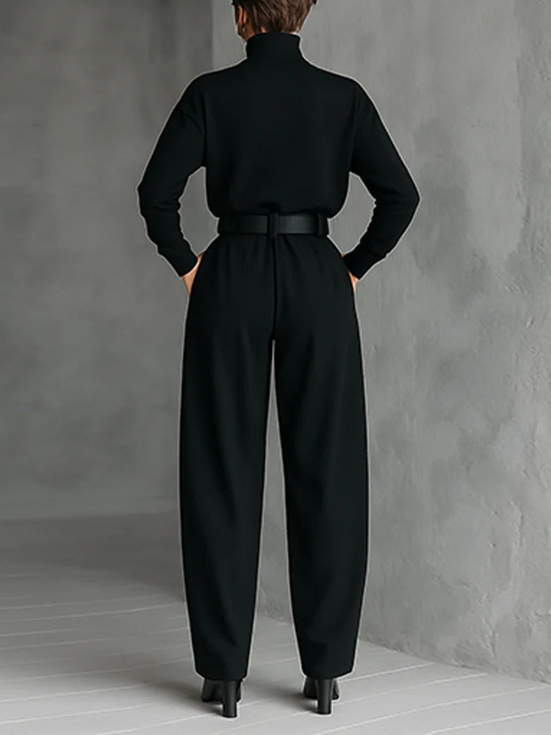 Black turtleneck top and straight-leg trousers with matching belt
