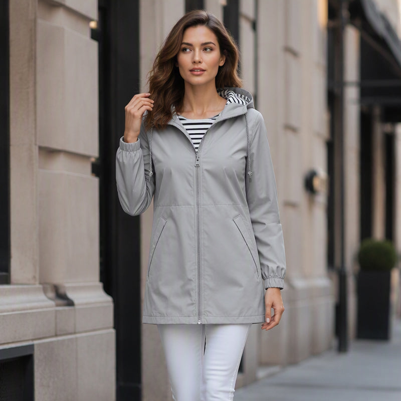 Woman wearing the grey lightweight hooded jacket on a city street